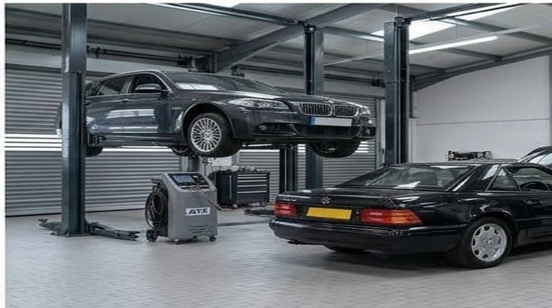 Rootes Motors workshop — BMW on the lift, Mercedes on the floor